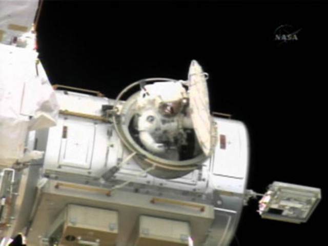 Astronauts outside airlock