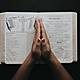Person placing hands on bible 2258251 (1)