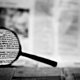 Magnifying glass newspaper shutterstock 3383425 1068x601