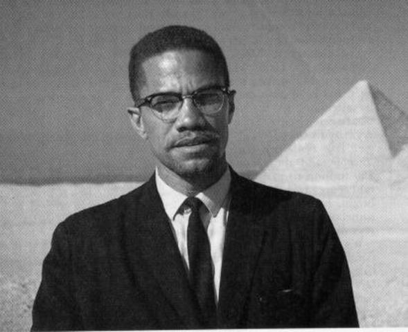 Malcolm X is shot as he prepares to deliver a speech