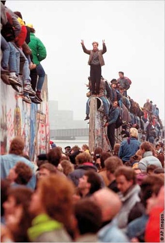 Berliners begin to tear down the Berlin Wall