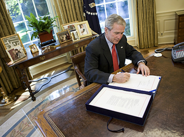 President Bush signs a $700 billion bailout bill
