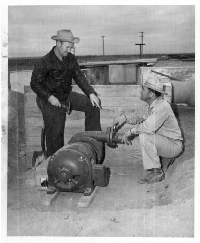 A.L. Hales and son prepare to connect a pump which will provide pressure for irrigation to the Hales farm