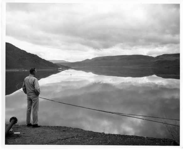 Photographer H.W. Fuller looks over Lake Roosevelt behind the Grand Coulee Dam