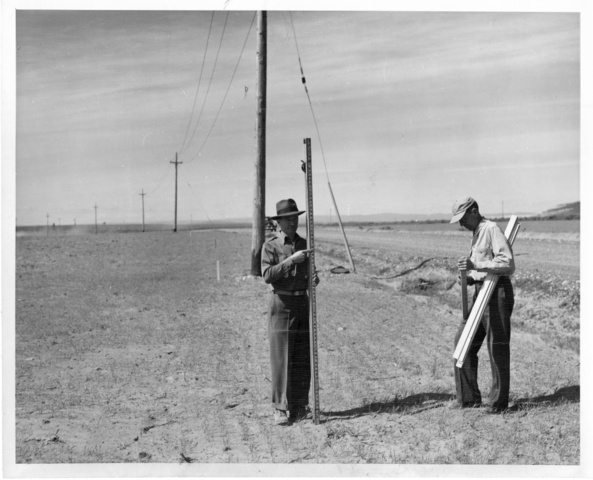 Bureau of Reclamtion surveyor aids W.F. Gillum in laying out farm ditches on Pasco Unit land