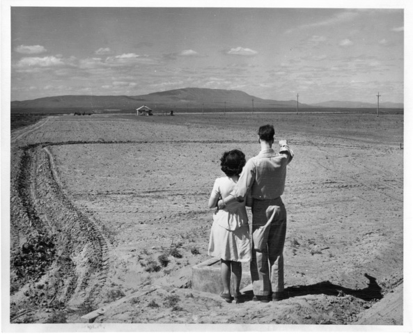 Warren Clifford and wife stand near the water delivery point for their Pasco Irrigation Unit farm