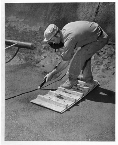 Contractor applies asphalt to joint sublateral of Pasco Unit