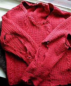 Mrs. Price put the red sweater on her desk.