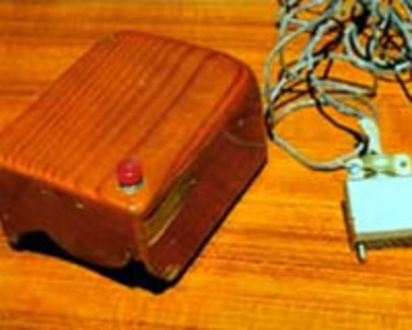 Douglas C. Engelbart demonstrates the first computer mouse (made of wood.)
