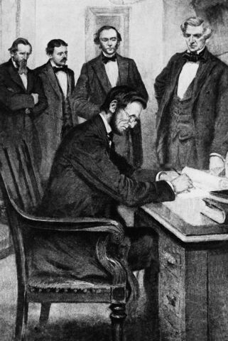 Lincoln signs the Emancipation Proclamation.