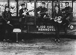 Lennon's art-school friend Stuart Sutcliffe joined and played bass.