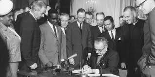 The Civil Rights Act of 1964 signed by President Johnson
