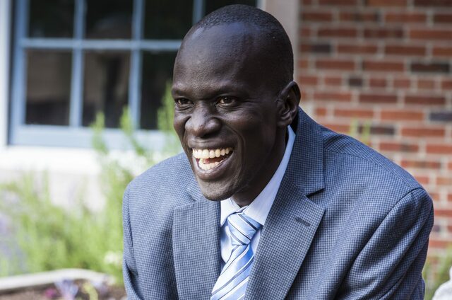 Nya notices the well operator, and shyly says hello to him. She thanks him for bringing water to her community,