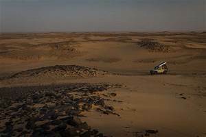 Nya and other children sees men driving up to them on a jeep