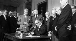 The Civil Rights Act of 1964 signed by President Johnson