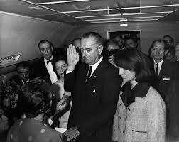 Lyndon B. Johnson is sworn in as President as the United States onboard Air Force One, two hours after Kennedy was assassinated