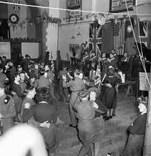 LAND GIRLS AND BRITISH SOLDIERS AT A DANCE