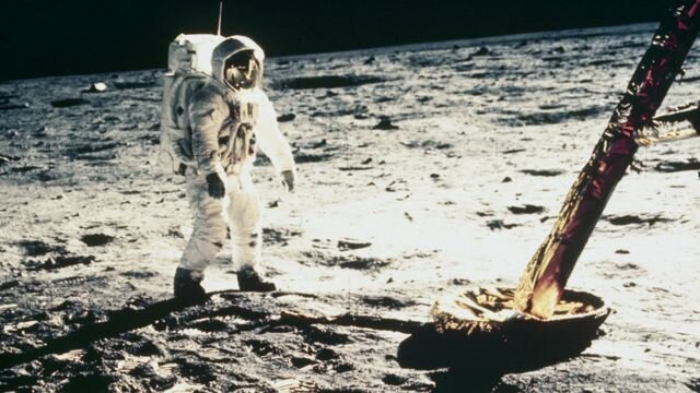 Apollo 11 astronauts land on the moon.