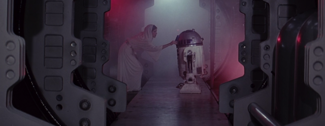Princess Leia puts some kind of chip into R2-D2