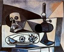 skull, urchins and lamp on a table