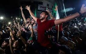 Palestinian supporters of the Islamic group Hamas celebrate their victory