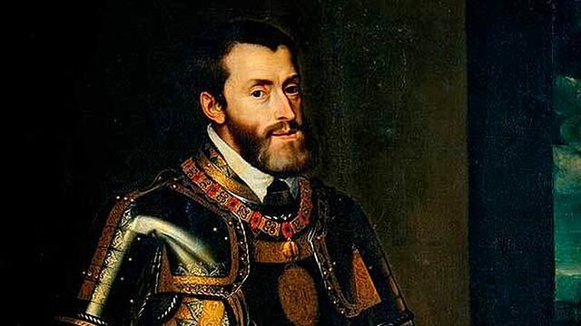 Carlos I abdica en su hijo Felipe y en su hermano Fernando. Se retira al monasterio de Yuste, donde muere en 1558