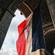 Arc de triomphe in paris, france  with the flag of france