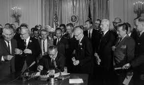 The Civil Rights Act of 1964 signed by President Johnson