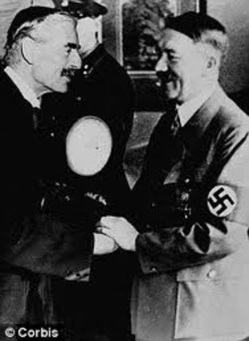 Chamberlain makes an agreement with Hitler to anex the Sudetenland