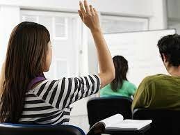 Raising up hands to answer questions in class