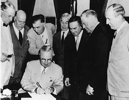 President Truman signs the Atomic Energy Act of 1946.