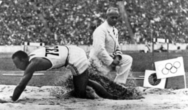 Owens wins four gold medals in the Olympic Games sets new world records.