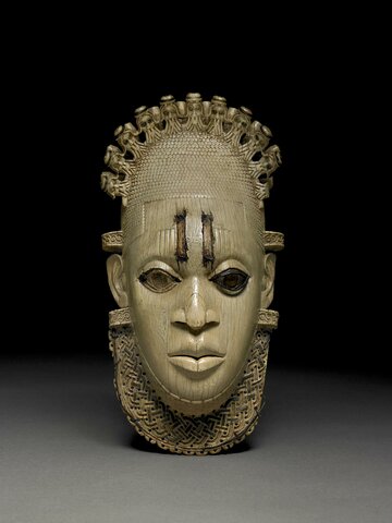 Hip pendant in the form of a woman’s face, perhaps Queen Mother Idia, mother of Oba Esigie (c. 1504-50), Benin, 16th century, ivory. British Museum