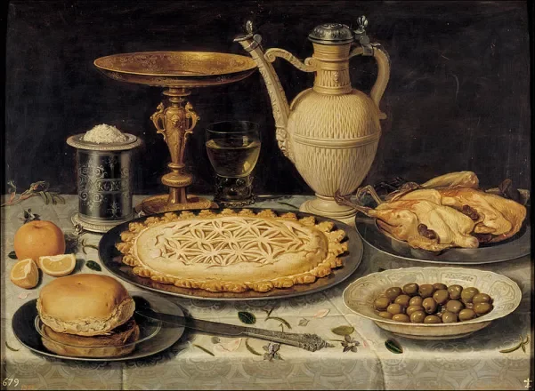 Table with oranges, olives, and pie