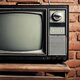 Depositphotos 11324319 stock photo retro grunge tv against brick