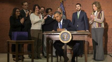 President Obama signs the $1.1 trillion budget