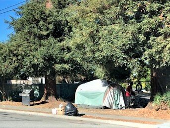 Trash and tent on Morgan Street at 9th Street