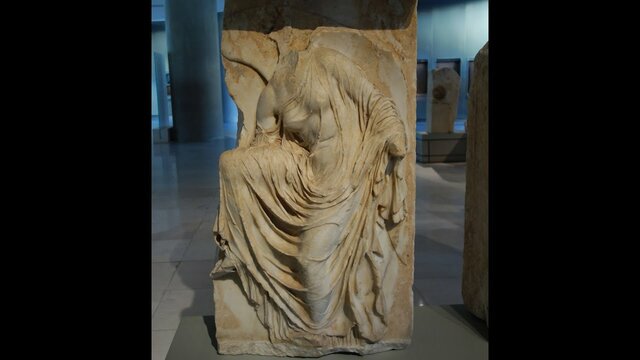 Victory (Nike) adjusting her sandal