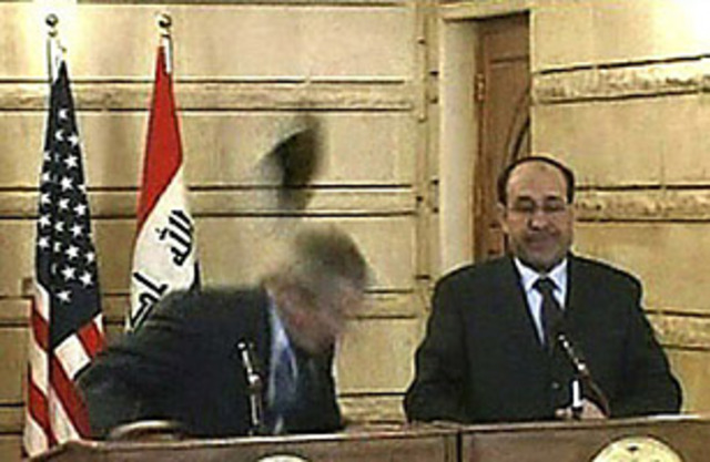 Iraqi journalist throws a shoe at President Bush during a speech.