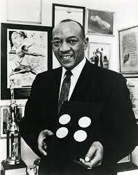 Jesse Owens wins four gold medals at Summer Olympics in Berlin, Germany