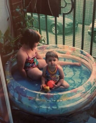 In a little kid pool with my younger sister Amna :)