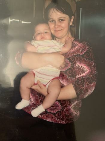 My mom holding me
