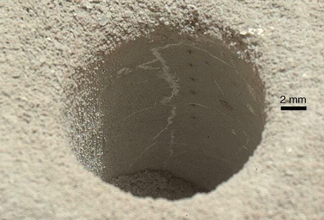 "John Klein" mudstone - drill hole (1.6 cm (0.63 in)) made by Curiosity