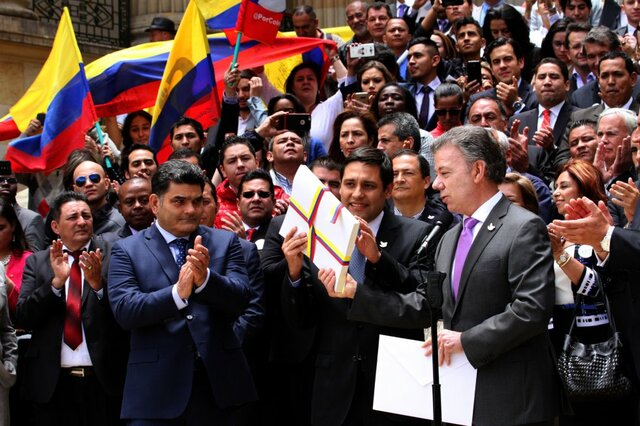 The Colombian government and the FARC rebels sign a historic cease-fire.