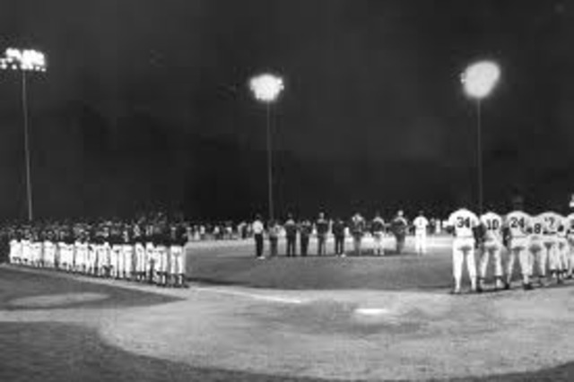 Major League Baseball's first night game is played.