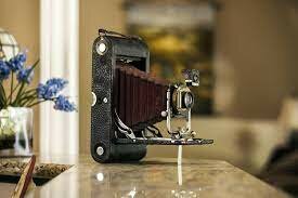 George Eastman invented the first handheld camera and rolled film.