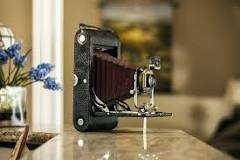 George Eastman invented the first handheld camera and rolled film.