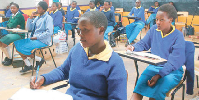 The US suspends $7m of funding for free primary schools in Kenya until fraud allegations are investigated.