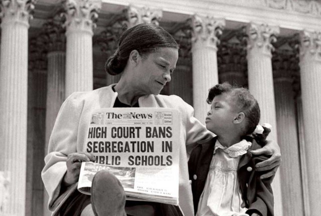 Brown v Board of Education bans racial segregation in school