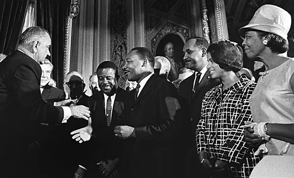 President Johnson signs the  new Voting Rights law